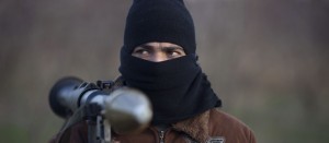 A Syrian soldier who defected to join the Free Syrian Army carries a rocket-propelled grenade as he poses for a photograph outside the town of Qusair