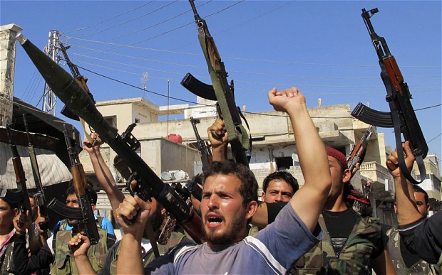  Members of the FSA chant slogans against Bashar al-Assad in the Aleppo province. Many fighters complain they are no longer battling for freedom Photo: Reuters