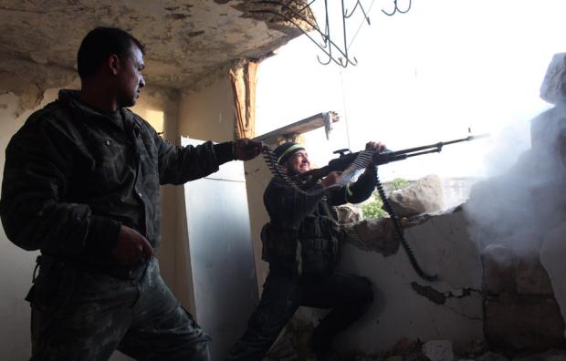  Rebel fighters fire a machine gun during clashes with pro-government forces on March 18, 2014 in the northern Syrian city of Aleppo. (Photo: AFP- AMC/Tamer al-Halabi) 