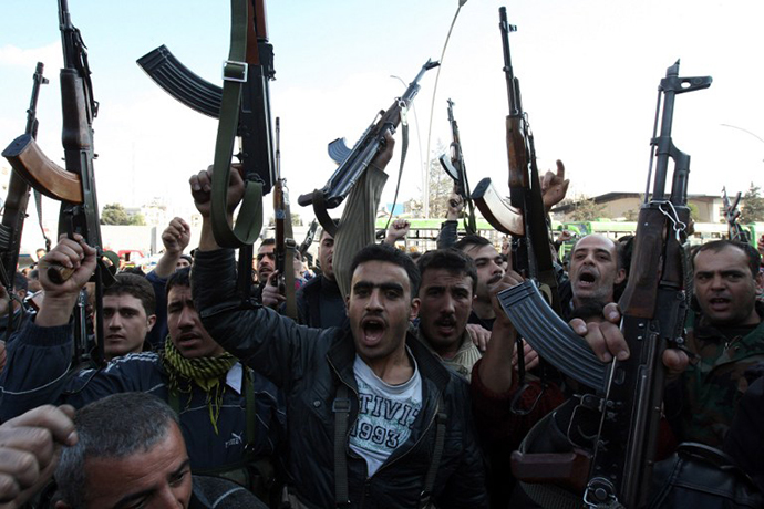 Syrian security men react after a security base was targeted by a suicide attack in Damascus on December 23, 2011. (AFP Photo / Louai Beshara)