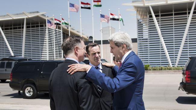 US Secretary of State John Kerry (R) speaks with US Ambassador to Iraq Robert Stephen Beecroft (L) and Deputy Assistant Secretary of State Brett McGurk before departing from Arbil International Airport, Arbil, Iraq, June 24, 2014.