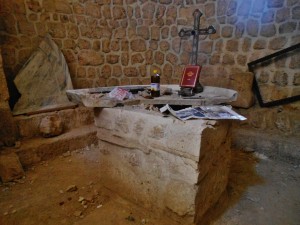 Smashed altar of Sts. Sergius et Bacchus, Ma'aloula. Dating  from early 4th century AD, it was unique in its half-circle, rimmed (vs rectangular and flat) design.